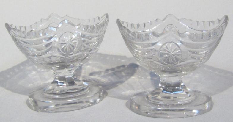 A pair of George III cut glass open salts, each of boat shaped outline on oval feet, 8cm high. (2)