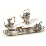 An Edwardian novelty silver miniature service, by Reynolds & Westwood, comprising coffee pot, 5cm