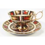 A Royal Crown Derby Imari pattern teacup and saucer, 15cm dia. no. 1128, printed marks beneath. (2)