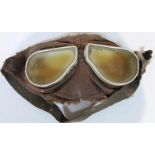 A pair of mid-20thC leather flying goggles, with shape tinted glass centres and elasticated strap,