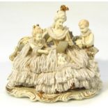A 20thC Dresden Art W R crinoline ladies figure, of a seated lady reading flanked by children in