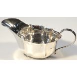 A George VI silver sauce boat, by Josiah Williams & Co. of slipper outline with wavy edge rim and