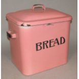 An early 20thC pink enamel bread bin, with domed lid and fixed handle, the main body entitled Bread,