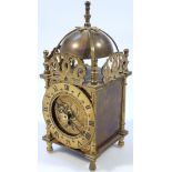 A modern Smith's lantern clock, the 8cm dia. dial with Roman numerals surmounted by a bell, in a