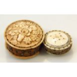 A 19thC carved ivory pin cushion, the circular outline with floral top and material centre set