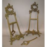 A rococo style brass table easel, in the rococo style with a scroll and floral pierced ring top, H