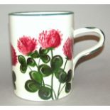 A 19thC Wemyss ale tankard, the cylindrical body hand painted with flowers in green and pink with an