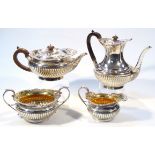 An Edwardian silver and silver gilt four piece tea service, with J Hall & Co. retailers mark