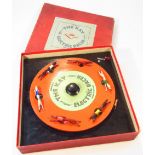 A mid-20thC Kay Company electric racer game, no. 1053, set with a circular turn table, polychrome