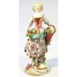 A late 18thC porcelain figure, of a lady in standing pose dressed in finery, predominantly in