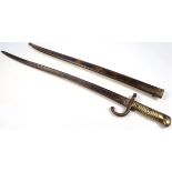 A mid-19thC French long bayonet, the shaped blade with scabbard engraved to the edge, Imto De Chat