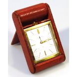 A 20thC Jaeger Le Coultre travel clock, in gilt metal outline, no. 111370, with square dial with