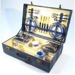 A mid-20thC Brexton picnic hamper, the rectangular pressed blue leatherette case hinging to revel