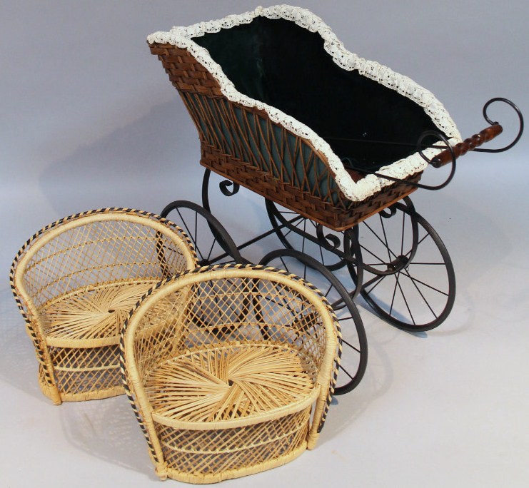 A Victorian style child's pram, the shaped basket weave top on an iron frame with spoke wheels,