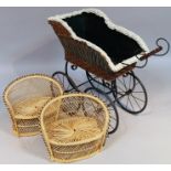 A Victorian style child's pram, the shaped basket weave top on an iron frame with spoke wheels,