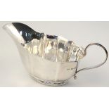 A George VI silver sauce boat, by Josiah Williams & Co. of slipper outline with wavy edge rim and