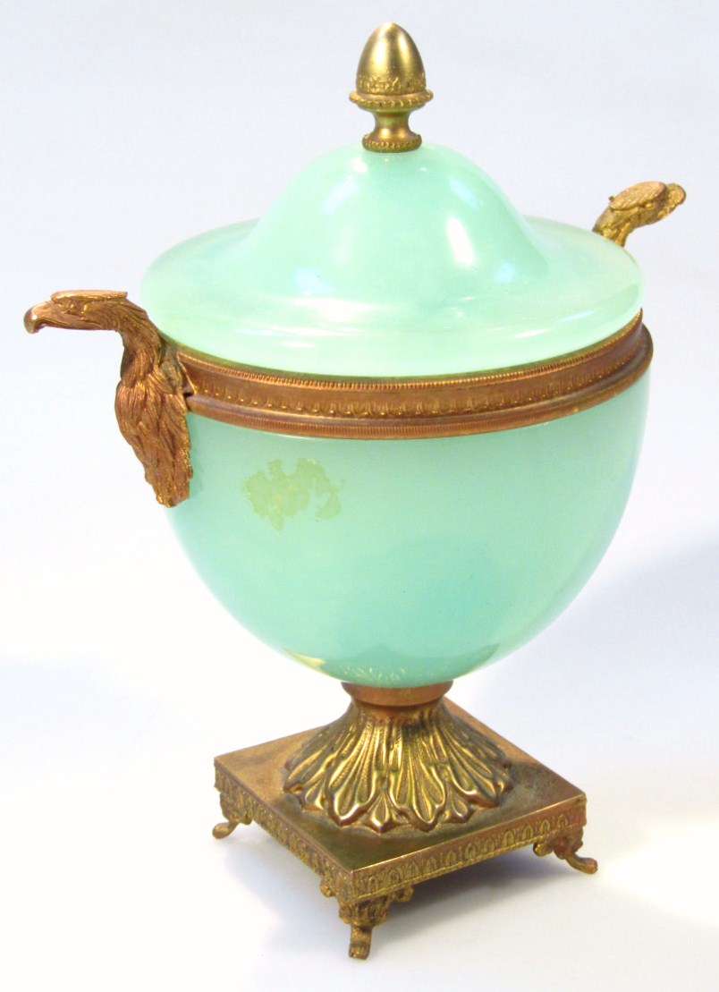A 20thC Grecian design glass and gilt metal vase, the domed lid with an acorn finial above egg