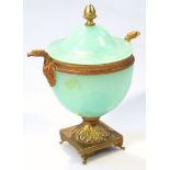 A 20thC Grecian design glass and gilt metal vase, the domed lid with an acorn finial above egg
