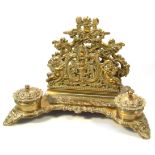 An early 20thC brass desk tidy, the rococo designed body set with a pierced back section