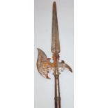 A ceremonial pike, with oak cylindrical handle and metal end etched with various geometric flowers