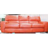 A red hide three seater sofa, 220cm long, 93cm deep, 87cm high.