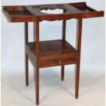 A George III mahogany wash stand, the square top with a hinged centre revealing a space for a wash