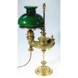 A 20thC Aladdin's brass table lamp, surmounted by a cylindrical acanthus capped handle with a