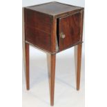 An early 19thC mahogany bedside cabinet, of square outline with front hinge door revealing a plain