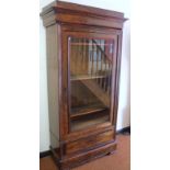A 19thC flame mahogany display cabinet, with an elaborate carved cornice raised above a single