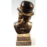 A 20thC bronze and marble finish bust, of a gentleman quarter profile in top hat and bow tie on a