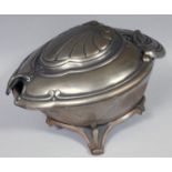 An Art Nouveau design metal coal box, the articulated hinged lid of shaped outline centred with a