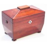 A Regency mahogany tea caddy, the sarcophagus shaped top hinging to reveal a two sectional