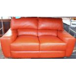 A red hide three seater sofa, 220cm long, 93cm deep, 87cm high.