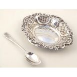 An Edwardian silver pin dish, the shaped outline set with scrolls and flowers, repoussé decorated