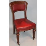 A late 19thC mahogany dining chair, the shaped back and seat overstuffed in red leather on turned