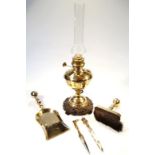 Various brass ware, comprising an oil lamp with clear glass funnel on a baluster column and metal