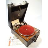 A mid-20thC Dulcetto tabletop gramophone, in a pressed black leather case with metal mounts, hinging