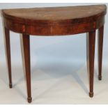 A George III mahogany fold-over D-end tea table, with a wide rosewood cross banding raised above