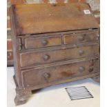 A 19thC tradesman's piece miniature oak bureau, the fall front hinging to reveal a fitted interior