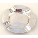 An Edwardian silver ashtray, the circular outline broken by four inverted sections, Birmingham 1906,