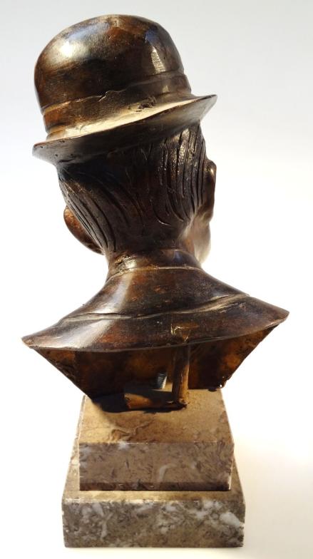 A 20thC bronze and marble finish bust, of a gentleman quarter profile in top hat and bow tie on a - Image 2 of 3