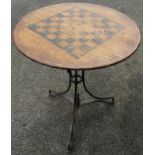 A 19thC mahogany games table, the circular chessboard top on an inverted metal stem terminating in