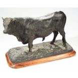 A hollow bronze finish statue, of a Charolais bull, bearing date for 1844, indistinctly signed on