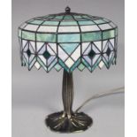 A modern Tiffany design table lamp, with domed cover decorated with panels in green and blue on a