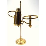 An early 20thC brass table light, with a cylindrical back and turned stem flanked by circular dish