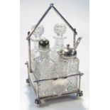 An early 20thC silver plated and cut glass four piece cruet set, the bamboo shaped framework fronted