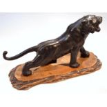 A Japanese figure of a standing tiger in roaring pose, on (removable) wooden base, three character