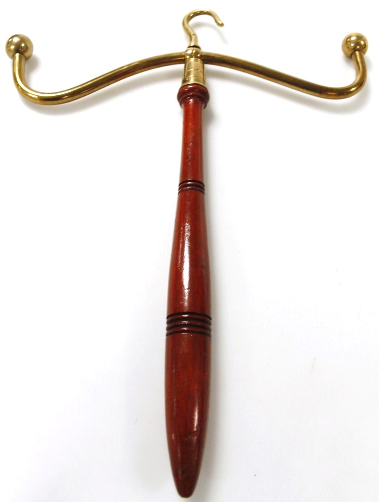 A portable brass wig stand, with a turned treen handle.
