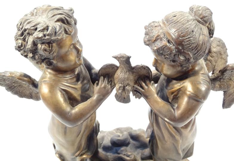 A 20thC bronzed classical figure group, of two cherubs standing holding a bird on a naturalistic - Image 3 of 3