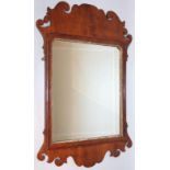 A 19thC walnut framed pier glass, the shaped scroll frame centred by a plain mirror with an outer